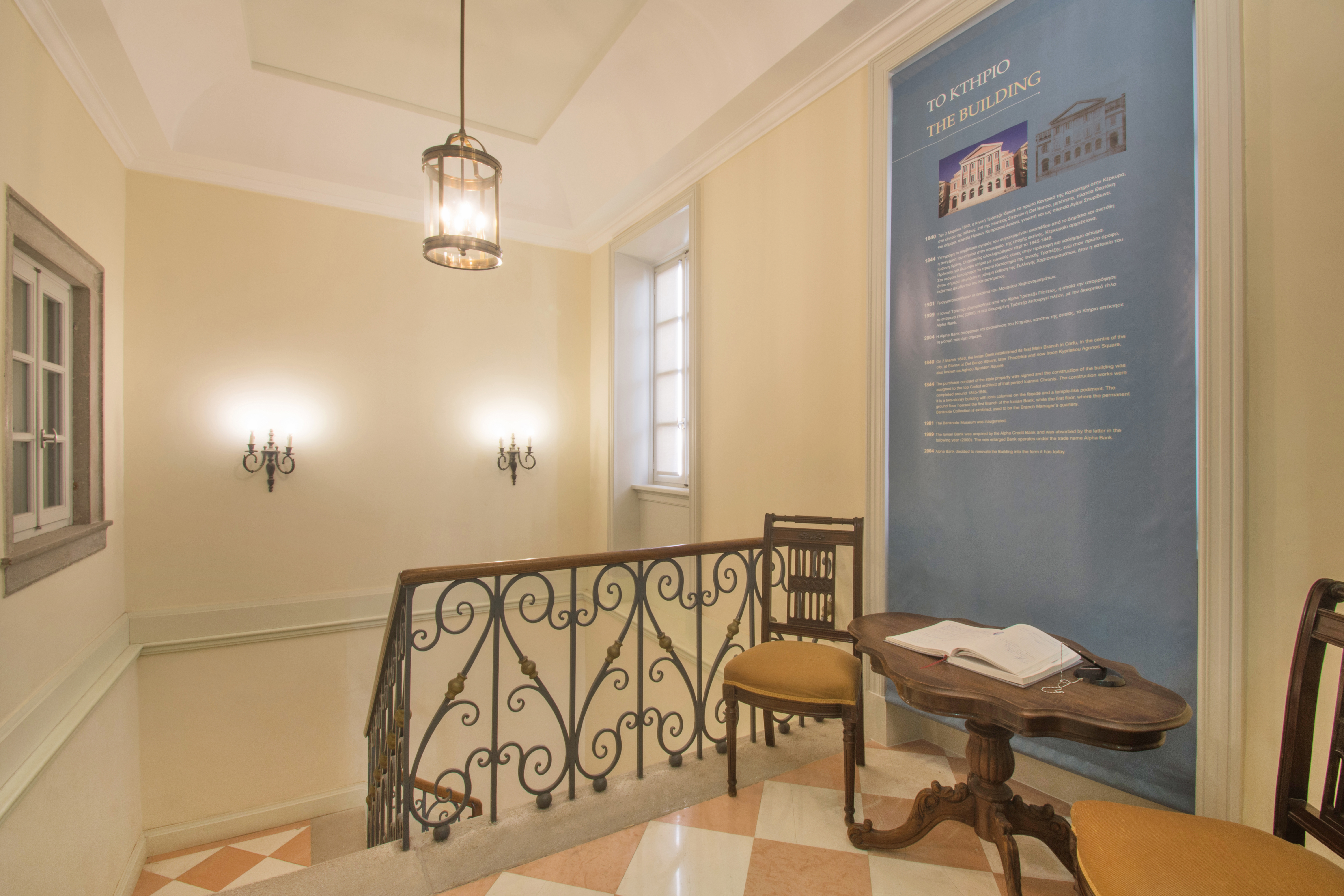 Wall poster with two chairs in front at the Banknote Museum of Ionian Bank.