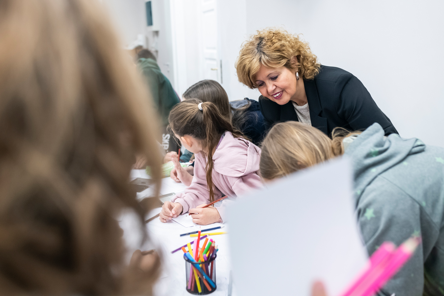 Dr Dimitra Tsangari admiring student paintings. Workshop at the Amfissa Cultural Centre