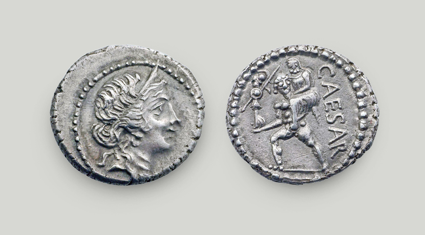 Two sides of denarius of Julius Caesar. On the obverse head of Aphrodite, on the reverse Aeneas carrying his father on his shoulders.  Two sides of silver denarius of Julius Caesar