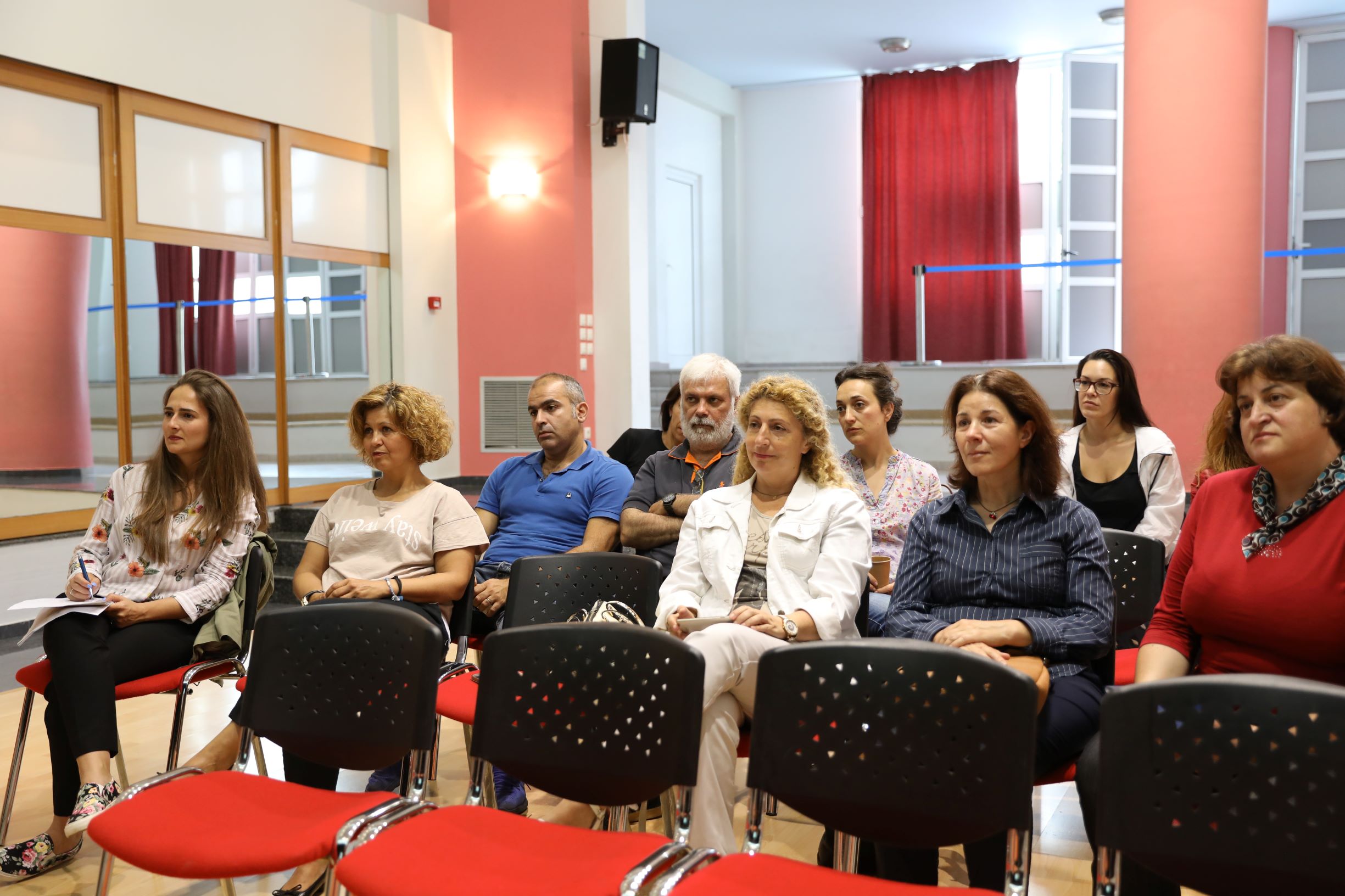 Audience seated on chairs.  Photo from meeting with teachers from schools on Rhodes