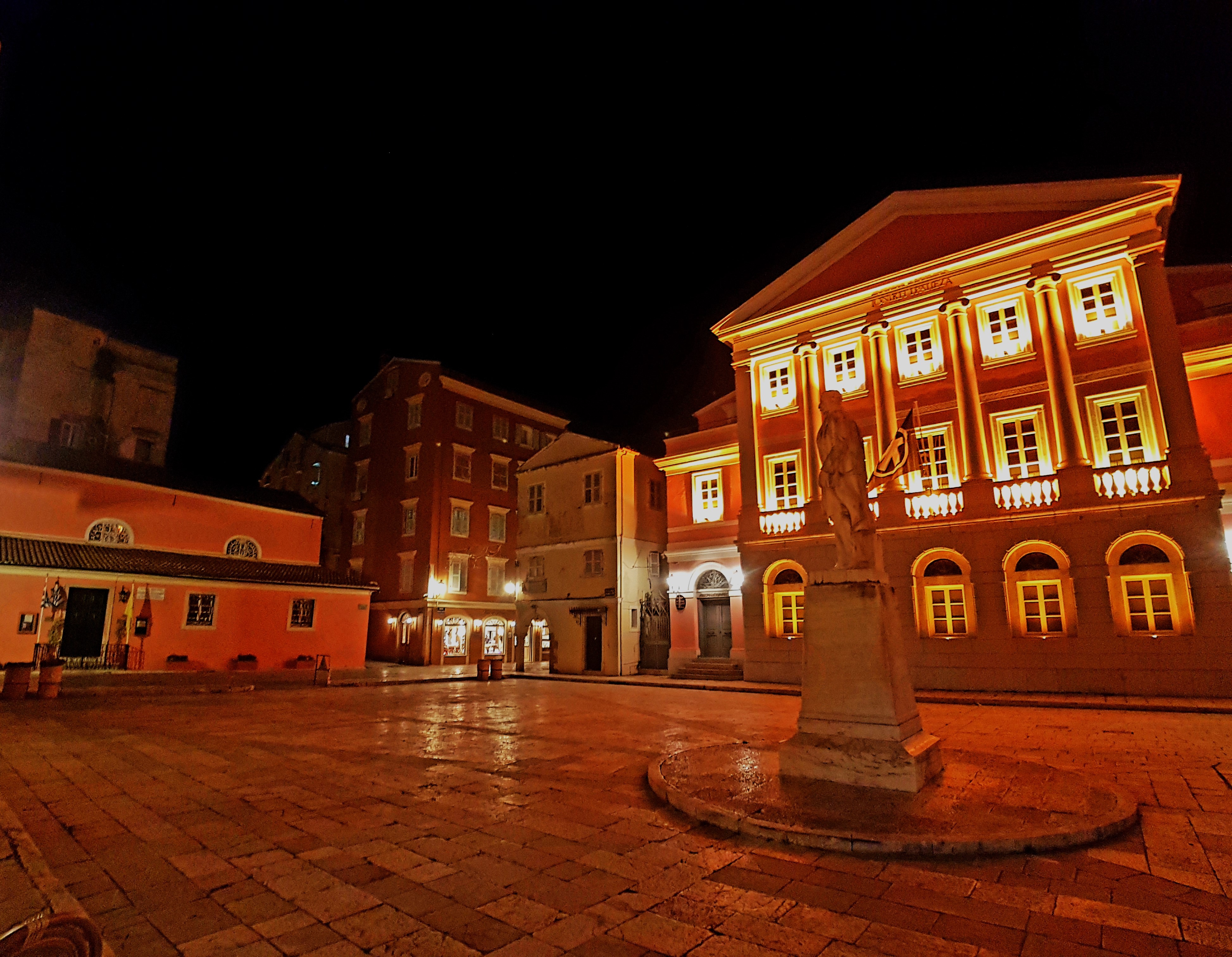 City square with illuminated building 