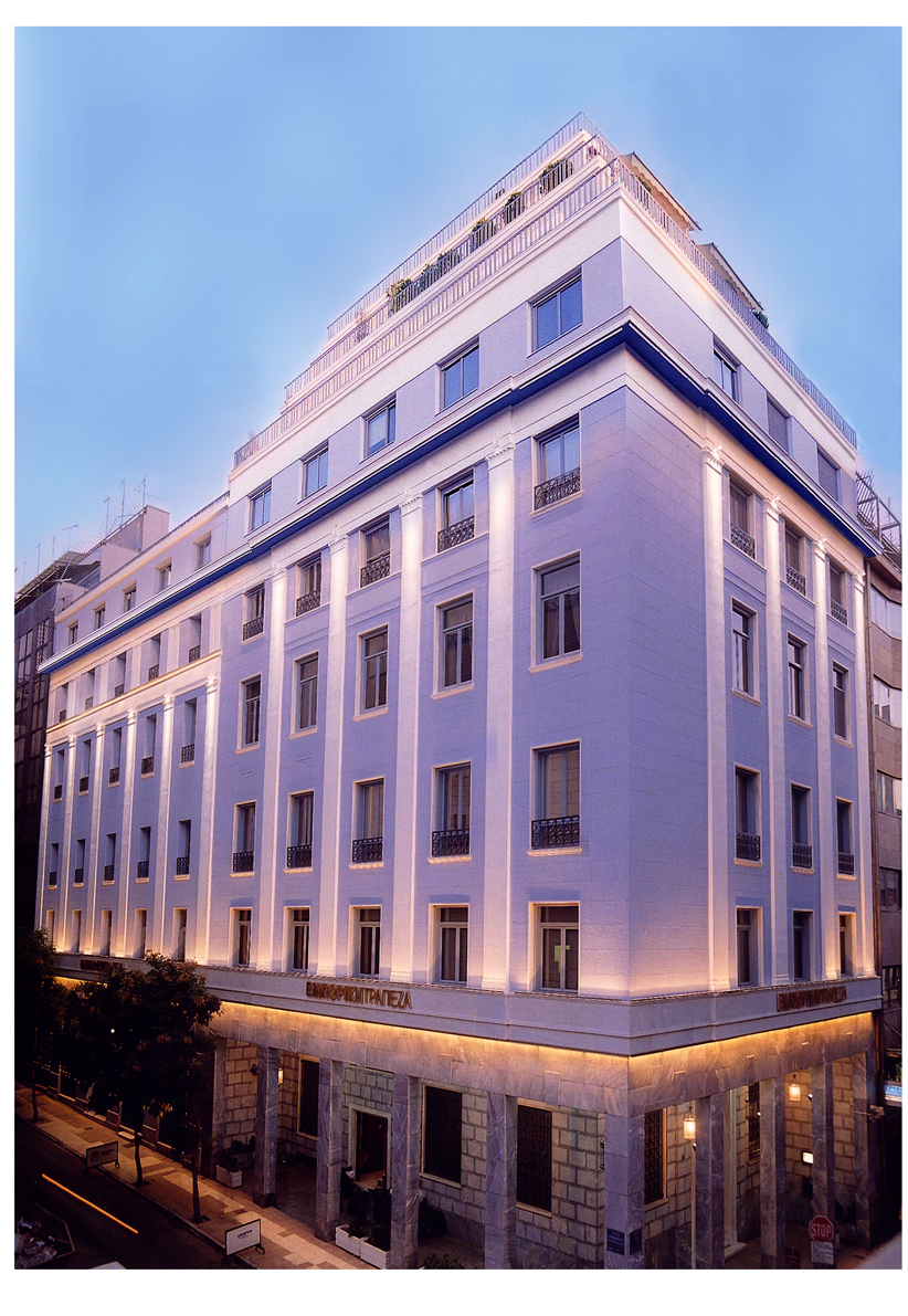 More recent colour photo of Emporiki Bank’s lit-up headquarters at the corner of Sofokleous and Aiolou Streets.  The Emporiki Bank headquarters