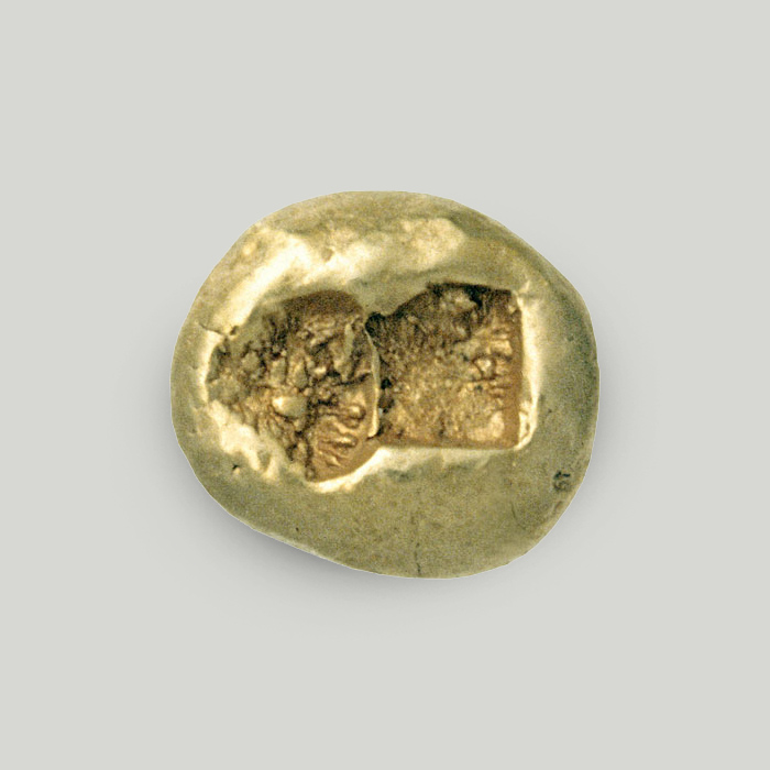 Obverse of hecte (1/6 stater), Ionia/Lydia. Gold-coloured metal roundel with irregularly shaped impression.  Reverse of electrum hecte (1/6 stater), Ionia/Lydia