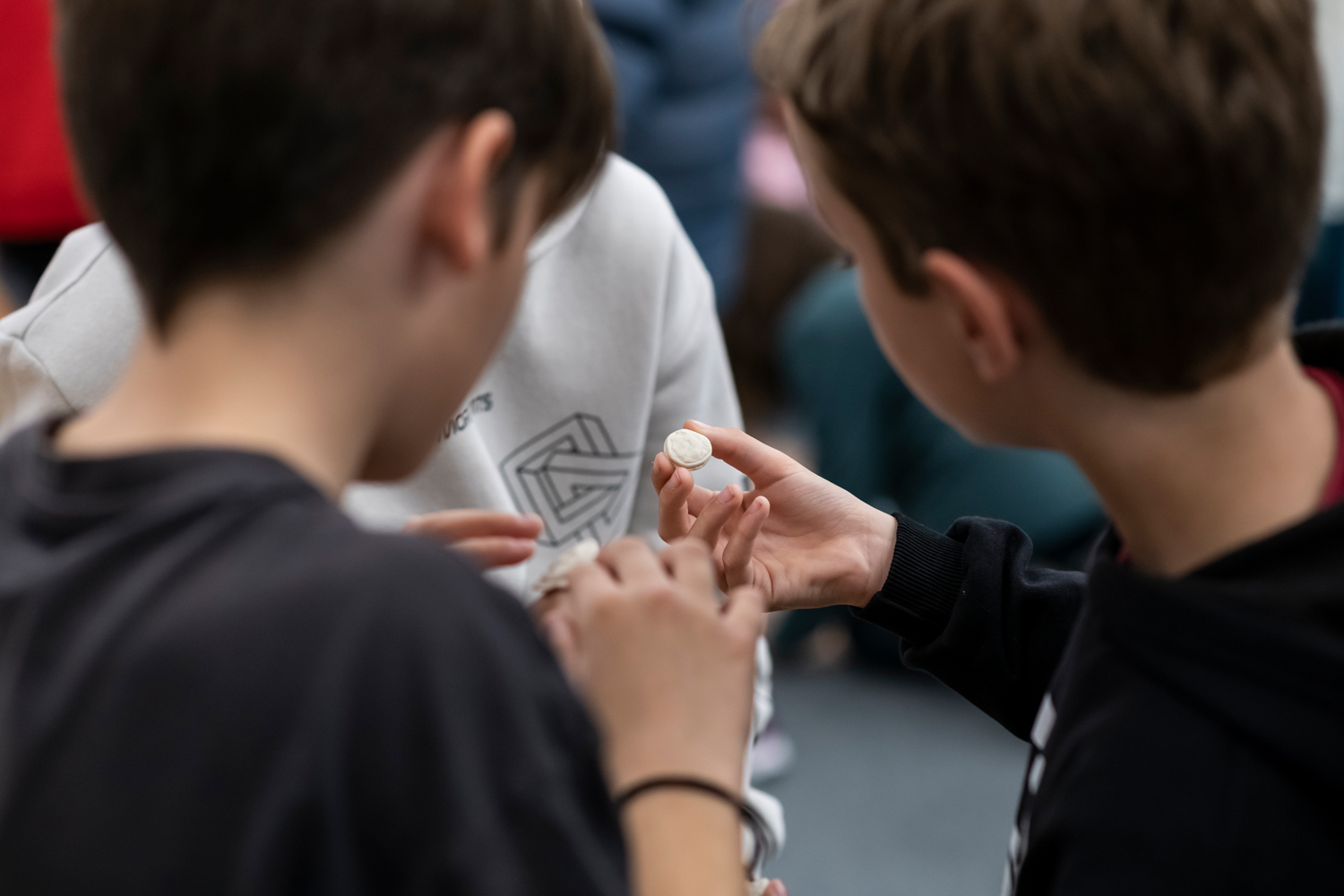Students observing the clay coins they created. Workshop at the Amfissa Cultural Centre