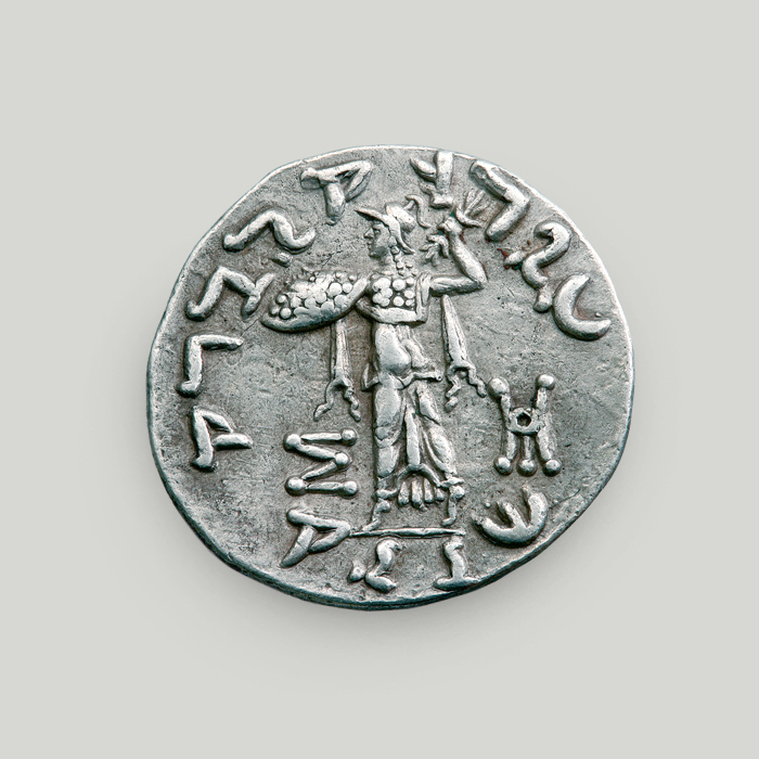 Reverse of silver tetradrachm of Menander I depicting goddess Athena holding shield and thunderbolt.  Reverse of silver tetradrachm of Menander I, Indo-Greek Kingdom