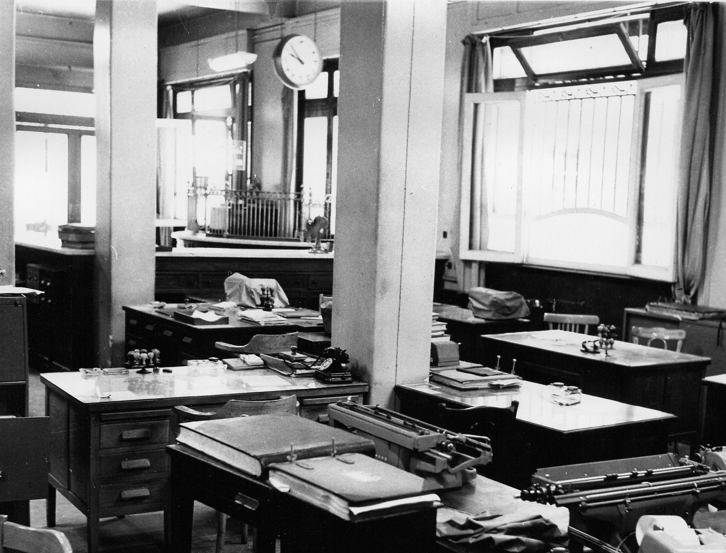 Interior of a Commercial Bank of the Near East branch with desk arrangement.   Interior of a Commercial Bank of the Near East branch