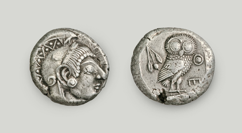 The obverse depicts a head of the goddess Athena. The reverse depicts an owl and an olive branch, along with the legend ATHE.  Silver tetradrachm, Athens, 500-480 BCE