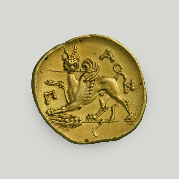 Reverse of Panticapaeum gold stater depicting a griffin on a wheat stalk holding a spear in its mouth, with legend reading PAN.   Reverse of Panticapaeum gold stater