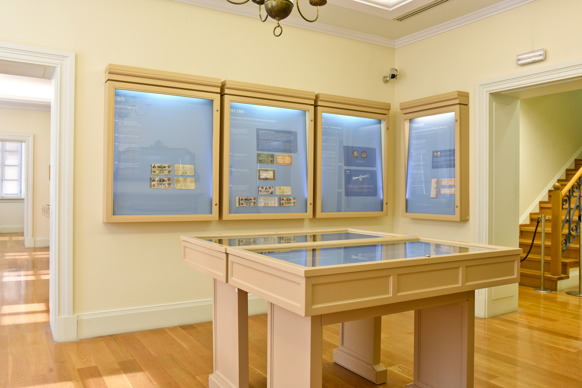 Hall at the Banknote Museum of Ionian Bank with coins in display cases.